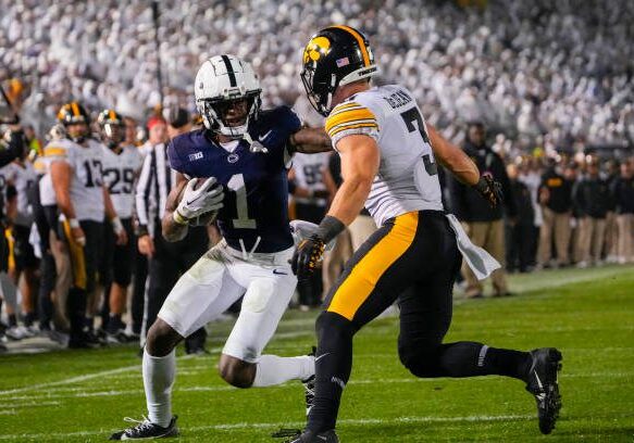 UNIVERSITY PARK, PA - SEPTEMBER 23: Penn State Nittany Lions Wide Receiver KeAndre Lambert-Smith (1) runs with the ball after making a catch with Iowa Hawkeyes Defensive Back Cooper DeJean (3) defending during the second half of the College Football game between the Iowa Hawkeyes and Penn State Nittany Lions on September 23,2023, at Beaver Stadium in University Park, PA. (Photo by Gregory Fisher/Icon Sportswire via Getty Images)