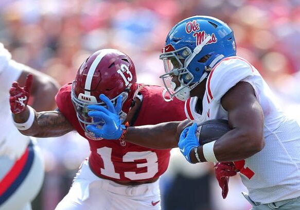 TUSCALOOSA, ALABAMA - SEPTEMBER 23:  Quinshon Judkins #4 of the Mississippi Rebels stiff arms Malachi Moore #13 of the Alabama Crimson Tide during the first quarter at Bryant-Denny Stadium on September 23, 2023 in Tuscaloosa, Alabama. (Photo by Kevin C. Cox/Getty Images)