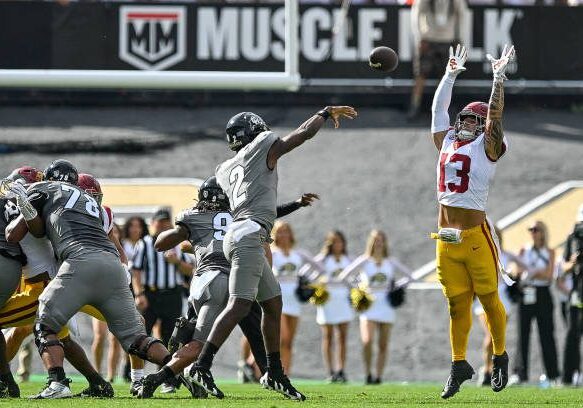 BOULDER, CO - SEPTEMBER 30: Mason Cobb #13 of the USC Trojans bats down a pass attempt by Shedeur Sanders #2 of the Colorado Buffaloes in the first quarter of the game at Folsom Field on September 30, 2023 in Boulder, Colorado. (Photo by Dustin Bradford/Getty Images)