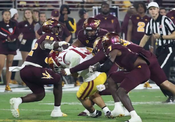 TEMPE, ARIZONA - SEPTEMBER 23: Caleb Williams #13 of the University of California Trojans is swarmed and sacked by defenders in the second quarter against the Arizona State Sun Devils at Mountain America Stadium on September 23, 2023 in Tempe, Arizona. (Photo by Bruce Yeung/Getty Images)