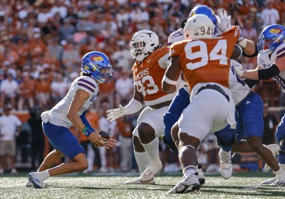 AUSTIN, TEXAS - SEPTEMBER 30: Jason Bean #9 of the Kansas Jayhawks looks to avoid pressure by T'Vondre Sweat #93 of the Texas Longhorns and Jaray Bledsoe #94 in the fourth quarter at Darrell K Royal-Texas Memorial Stadium on September 30, 2023 in Austin, Texas. (Photo by Tim Warner/Getty Images)