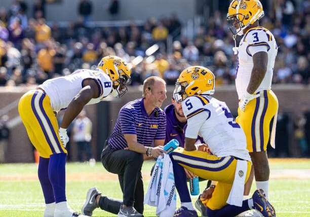 COLUMBIA, MISSOURI - OCTOBER 7:  LSU Tigers trainers attend to Jayden Daniels #5 of the LSU Tigers after an injury during the game against the Missouri Tigers at Faurot Field/Memorial Stadium on October 7, 2023 in Columbia, Missouri. (Photo by Michael Hickey/Getty Images)