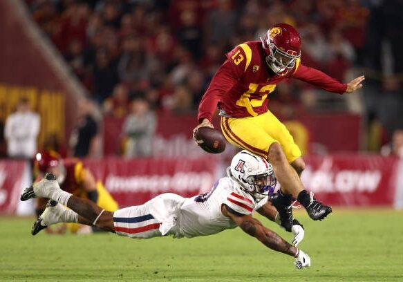 LOS ANGELES, CALIFORNIA - OCTOBER 07: Caleb Williams #13 of the USC Trojans avoids a tackle from Justin Flowe #10 of the Arizona Wildcats during the third quarter at United Airlines Field at the Los Angeles Memorial Coliseum on October 07, 2023 in Los Angeles, California. (Photo by Katelyn Mulcahy/Getty Images)