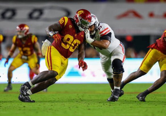 LOS ANGELES, CA - OCTOBER 07: USC Trojans defensive lineman Bear Alexander (90) rushes the passer and gets blocked by Arizona Wildcats offensive lineman Jordan Morgan (77) during a college football game between the Arizona Wildcats against the USC Trojans on October 07, 2023, at United Airlines Field at The Los Angeles Memorial Coliseum in Los Angeles, CA.(Photo by Jordon Kelly/Icon Sportswire via Getty Images)