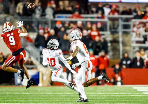 MADISON, WI - OCTOBER 28: Wisconsin wide receiver Bryson Green (9) leaps to catch the ball while Ohio State corner back Denzel Burke (10) and Ohio State safety Sonny Styles (6) look on during a college football game between the University of Wisconsin Badgers and the Ohio State University Buckeyes on October 28, 2023 at Camp Randall Stadium in Madison, WI. (Photo by Lawrence Iles/Icon Sportswire via Getty Images)