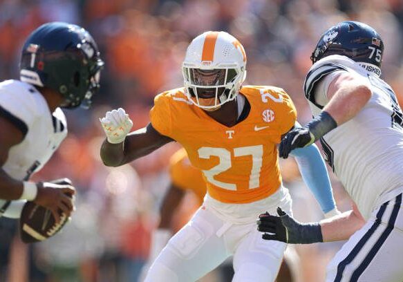 KNOXVILLE, TENNESSEE - NOVEMBER 04: James Pearce Jr. #27 of the Tennessee Volunteers defends against Devontae Houston #1 of the Connecticut Huskies and Chase Lundt #75 of the Connecticut Huskies at Neyland Stadium on November 04, 2023 in Knoxville, Tennessee. (Photo by Donald Page/Getty Images)