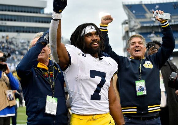 UNIVERSITY PARK, PA - NOVEMBER 11: Michigan running back Donovan Edwards (7) celebrates as he leaves the field after the Michigan Wolverines versus Penn State Nittany Lions game on November 11, 2023 at Beaver Stadium in University Park, PA. (Photo by Randy Litzinger/Icon Sportswire via Getty Images)