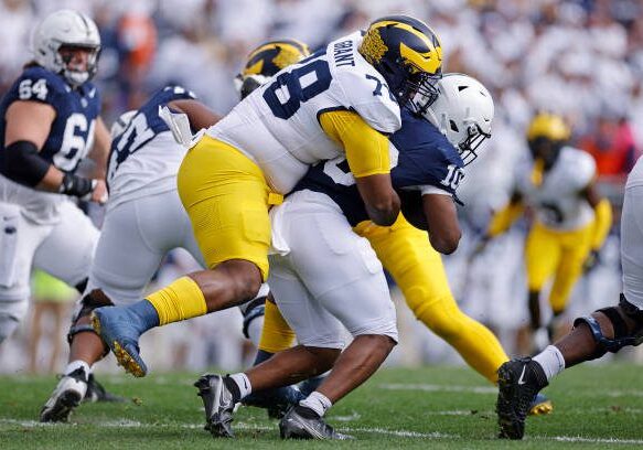 UNIVERSITY PARK, PA - NOVEMBER 11: Michigan Wolverines defensive lineman Kenneth Grant (78) tackles Penn State Nittany Lions running back Nicholas Singleton (10) for a loss of yardage during a college football game on November 11, 2023 at Beaver Stadium in University Park, Pennsylvania. (Photo by Joe Robbins/Icon Sportswire via Getty Images)