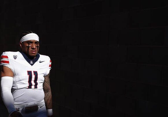 TEMPE, ARIZONA - NOVEMBER 25: Quarterback Noah Fifita #11 of the Arizona Wildcats walks out to the field before the NCAAF game against the Arizona State Sun Devils at Mountain America Stadium on November 25, 2023 in Tempe, Arizona. (Photo by Christian Petersen/Getty Images)