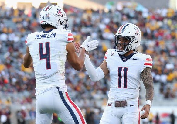 TEMPE, ARIZONA - NOVEMBER 25: Wide receiver Tetairoa McMillan #4 of the Arizona Wildcats celebrates with Noah Fifita #11 after catching a 50-yard touchdown reception against the Arizona State Sun Devils during the second half of the NCAAF game at Mountain America Stadium on November 25, 2023 in Tempe, Arizona. (Photo by Christian Petersen/Getty Images)