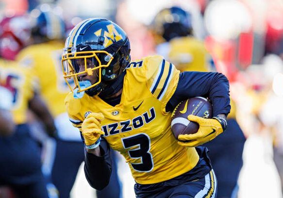 FAYETTEVILLE, ARKANSAS - NOVEMBER 24: Luther Burden III #3 of the Missouri Tigers runs the ball during the game against the Arkansas Razorbacks at Donald W. Reynolds Razorback Stadium on November 24, 2023 in Fayetteville, Arkansas.  The Tigers defeated the Razorbacks 48-14.  (Photo by Wesley Hitt/Getty Images)