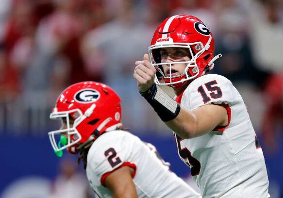 ATLANTA, GEORGIA - DECEMBER 02: Carson Beck #15 of the Georgia Bulldogs signals the play to teammates during the first quarter against the Alabama Crimson Tide in the SEC Championship at Mercedes-Benz Stadium on December 02, 2023 in Atlanta, Georgia. (Photo by Todd Kirkland/Getty Images)