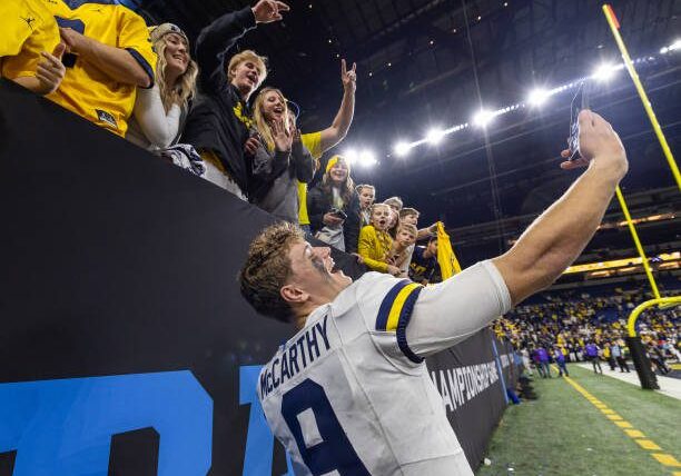 INDIANAPOLIS, INDIANA - DECEMBER 2:  J.J. McCarthy #9 of the Michigan Wolverines interacts with fans after the Big Ten Championship against the Iowa Hawkeyes at Lucas Oil Stadium on December 2, 2023 in Indianapolis, Indiana. (Photo by Michael Hickey/Getty Images)