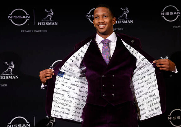 NEW YORK, NEW YORK - DECEMBER 09: Quarterback Michael Penix Jr. of the Washington Huskies displays the inside of his suit jacket during a press conference ahead of The Heisman Memorial Trophy ceremony at New York Marriott Marquis Hotel on December 09, 2023 in New York City. (Photo by Sarah Stier/Getty Images)