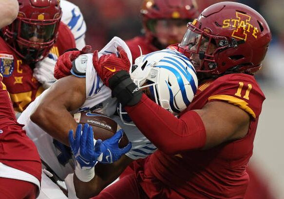 MEMPHIS, TENNESSEE - DECEMBER 29: Tyler Onyedim #11 of the Iowa State Cyclones tackles Blake Watson #4 of the Memphis Tigers during the first half of the 2023 AutoZone Liberty Bowl at Simmons Bank Liberty Stadium on December 29, 2023 in Memphis, Tennessee. (Photo by Justin Ford/Getty Images)