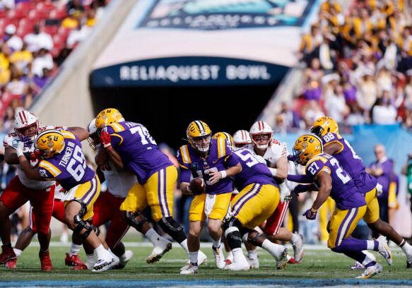 TAMPA, FL - JANUARY 01: LSU Tigers quarterback Garrett Nussmeier (13) turns to hand off during the ReliaQuest Bowl against the Wisconsin Badgers on January 1, 2024 at Raymond James Stadium in Tampa, Florida. (Photo by Joe Robbins/Icon Sportswire via Getty Images)