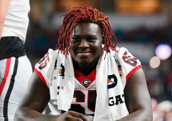 MIAMI GARDENS, FLORIDA - DECEMBER 30: Amarius Mims #65 of the Georgia Bulldogs celebrates after beating the Florida State Seminoles 63-3 to win the Capital One Orange Bowl at Hard Rock Stadium on December 30, 2023 in Miami Gardens, Florida. (Photo by Rich Storry/Getty Images)