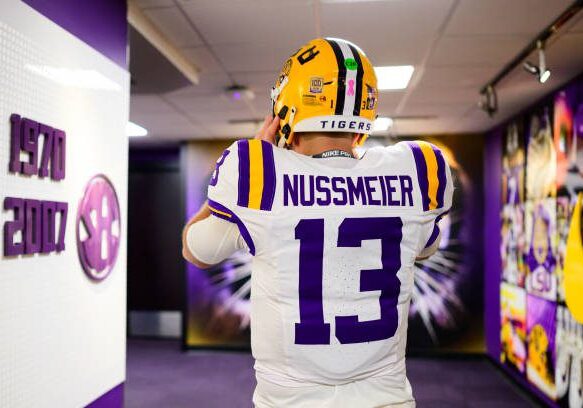 gettyimages-2177456299-612x612 BATON ROUGE, LOUISIANA - OCTOBER 12: Garrett Nussmeier #13 of the LSU Tigers tightens up his helmet as he heads out of the locker room before the game against the Ole Miss Rebels at Tiger Stadium on October 12, 2024 in Baton Rouge, Louisiana. (Photo by Gus Stark/LSU/University Images via Getty Images}