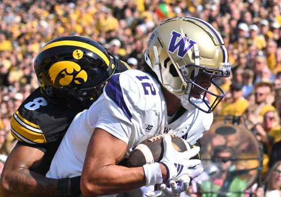 IOWA CITY, IA - OCTOBER 12: Iowa safety Deshaun (8) tackles Washington wide receiver Denzel Boston (12) as he catches a five-yard pass for a touchdown during a college football game between the Washington Huskies and the Iowa Hawkeyes, on October 12, 2024, at Kinnick Stadium, Iowa City, IA. (Photo by Keith Gillett/IconSportswire)