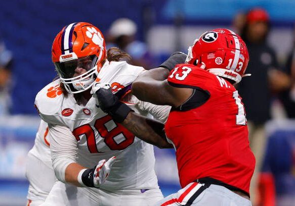 ATHENS, GEORGIA - AUGUST 31: Blake Miller #78 of the Clemson Tigers blocks Mykel Williams #13 of the Georgia Bulldogs during the first quarter in the Aflac Kickoff Game at Mercedes-Benz Stadium on August 31, 2024 in Atlanta, Georgia. (Photo by Todd Kirkland/Getty Images)