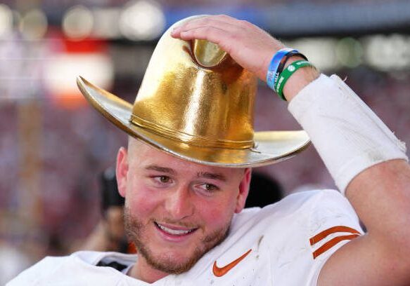 DALLAS, TEXAS - OCTOBER 12: Quinn Ewers #3 of the Texas Longhorns wears the Golden Hat Trophy after defeating the Oklahoma Sooners 34-3 at Cotton Bowl Stadium on October 12, 2024 in Dallas, Texas. (Photo by Sam Hodde/Getty Images)