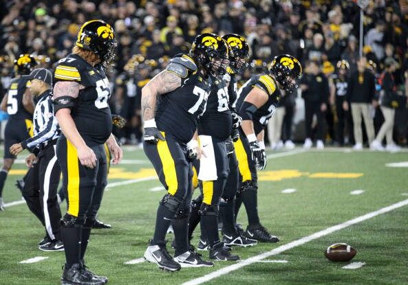 IOWA CITY, IOWA- NOVEMBER 02:  Offensive linemen Gennings Dunker #67, Logan Jones #65, Connor Colby #77, Beau Stevens #70 and Mason Richman #78 of the Iowa Hawkeyes walk to the line during the first half against the Wisconsin Badgers, at Kinnick Stadium. on November 2, 2024 in Iowa City, Iowa.  (Photo by Matthew Holst/Getty Images)