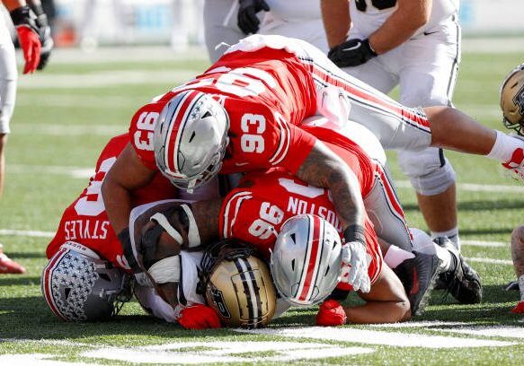 COLUMBUS, OH - NOVEMBER 09: Purdue Boilermakers running back Reggie Love III (23) is tackled by Ohio State Buckeyes safety Sonny Styles (6), defensive tackle Hero Kanu (93) and defensive end Eddrick Houston (96) during the game against the Purdue Boilermakers and the Ohio State Buckeyes on November 9, 2024, at Ohio Stadium in Columbus, OH. (Photo by Ian Johnson/Icon Sportswire via Getty Images)