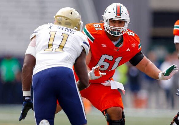 ATLANTA, GEORGIA - NOVEMBER 9: Francis Mauigoa #61 of the Miami Hurricanes looks to block Kevin Harris II #11 of the Georgia Tech Yellow Jackets during the first quarter at Bobby Dodd Stadium on November 9, 2024 in Atlanta, Georgia. (Photo by Todd Kirkland/Getty Images)