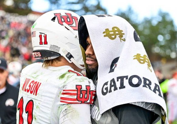 BOULDER, CO - NOVEMBER 16:  Shedeur Sanders #2 of the Colorado Buffaloes shakes hands with Isaac Wilson #11 of the Utah Utes on the field after a game at Folsom Field on November 16, 2024 in Boulder, Colorado. (Photo by Dustin Bradford/Getty Images)