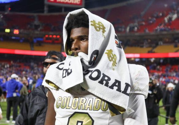 KANSAS CITY, MO - NOVEMBER 23: Colorado Buffaloes quarterback Shedeur Sanders (2) walks off the field with a towel over his head after a Big 12 game between the Colorado Buffaloes and Kansas Jayhawks on November 23, 2024 at GEHA Field at Arrowhead Stadium in Kansas City, MO. (Photo by Scott Winters/Icon Sportswire via Getty Images)