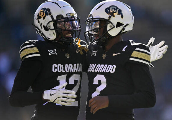 BOULDER, CO - NOVEMBER 29:  Shedeur Sanders #2 and Travis Hunter #12 of the Colorado Buffaloes celebrate after a third quarter touchdown against the Oklahoma State Cowboys at Folsom Field on November 29, 2024 in Boulder, Colorado. (Photo by Dustin Bradford/Getty Images)