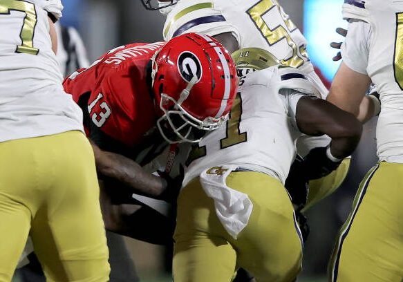 ATHENS, GA - NOVEMBER 29: Georgia Bulldogs defensive lineman Mykel Williams #13 tackles Georgia Tech Yellow Jackets running back Jamal Haynes #11 during the Friday evening college football game between the Georgia Bulldogs and the Georgia Tech Yellow Jackets on November 29, 2024 on Dooley Field at Sanford Stadium in Athens, Georgia.  (Photo by David J. Griffin/Icon Sportswire via Getty Images)