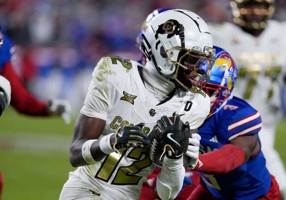 KANSAS CITY, MISSOURI - NOVEMBER 23: Wide receiver Travis Hunter #12 of the Colorado Buffaloes runs in the second half against the Kansas Jayhawks at Arrowhead Stadium on November 23, 2024 in Kansas City, Missouri.  (Photo by Ed Zurga/Getty Images)