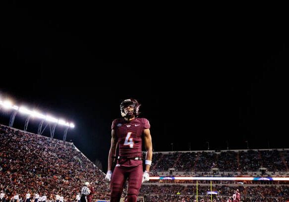 gettyimages-2187776388-612x612 BLACKSBURG, VIRGINIA - NOVEMBER 30: Mansoor Delane #4 of the Virginia Tech Hokies in the second half during a game against the Virginia Cavaliers at Lane Stadium on November 30, 2024 in Blacksburg, Virginia. (Photo by Ryan Hunt/Getty Images)