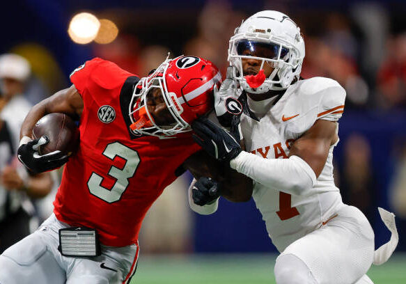 ATLANTA, GEORGIA - DECEMBER 7: Nate Frazier #3 of the Georgia Bulldogs is knocked out of bounds by Jahdae Barron #7 of the Texas Longhorns during the fourth quarter in the 2024 SEC Championship at Mercedes-Benz Stadium on December 7, 2024 in Atlanta, Georgia. (Photo by Todd Kirkland/Getty Images)