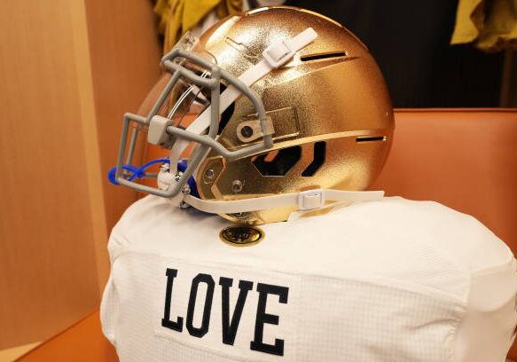 gettyimages-2192764727-612x612 MIAMI GARDENS, FLORIDA - JANUARY 9: The helmet of Jeremiyah Love #4 of the Notre Dame Fighting Irish in the locker room prior to the Orange Bowl game against the Penn State Nittany Lions at Hard Rock Stadium on January 9, 2025 in Miami Gardens, Florida. (Photo by CFP/Getty Images)
