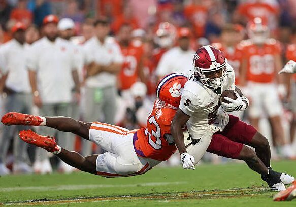 CLEMSON, SOUTH CAROLINA - SEPTEMBER 06: Wide receiver Mojo Dortch #5 of Troy gets tackled by cornerback Ashton Hampton #23 of Clemson during the fourth quarter of a game between Clemson and Troy at Memorial Stadium on September 6, 2025 in Clemson, South Carolina. (Photo by Cory Knowlton/ISI Photos/ISI Photos via Getty Images)