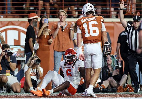 AUSTIN, TEXAS - SEPTEMBER 20: Arch Manning #16 of the Texas Longhorns celebrates in front of Antavious Fish #6 of the Sam Houston State Bearkats after a rushing touchdown in the first quarter at Darrell K Royal-Texas Memorial Stadium on September 20, 2025 in Austin, Texas. (Photo by Tim Warner/Getty Images)