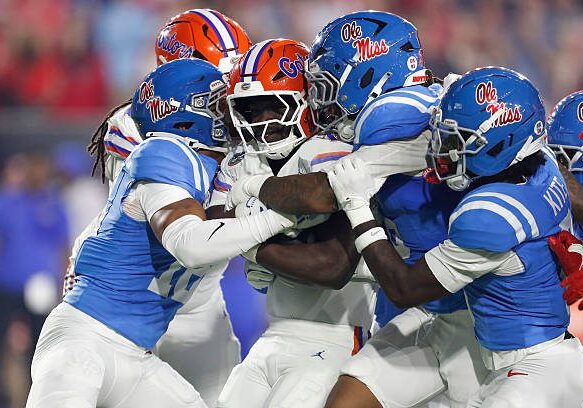OXFORD, MS - NOVEMBER 15:  Florida Gators running back Jadan Baugh (13) is tackled by a host of Ole Miss Rebels defenders during the college football game between the Florida Gators and Ole Miss Rebels on November 15, 2025, at Vaught-Hemingway Stadium in Oxford, Mississippi. (Photo by Andy Altenburger/Icon Sportswire via Getty Images)