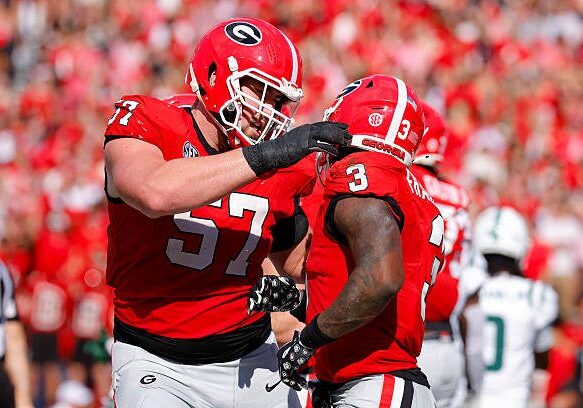 ATHENS, GEORGIA - NOVEMBER 22: Monroe Freeling #57 celebrates with Nate Frazier #3 of the Georgia Bulldogs following Frazier's touchdown during the first quarter against the Charlotte 49ers at Sanford Stadium on November 22, 2025 in Athens, Georgia. (Photo by Todd Kirkland/Getty Images)