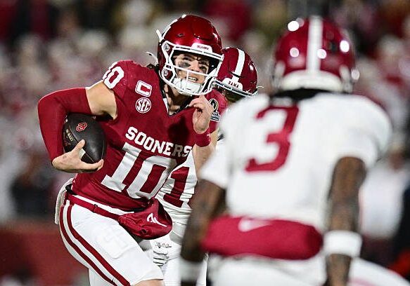 NORMAN, OKLAHOMA - DECEMBER 19: John Mateer #10 of the Oklahoma Sooners runs with the ball in the first half against the Alabama Crimson Tide during 2025 College Football Playoff First Round Game at Gaylord Family Oklahoma Memorial Stadium on December 19, 2025 in Norman, Oklahoma. (Photo by CFP/Getty Images)