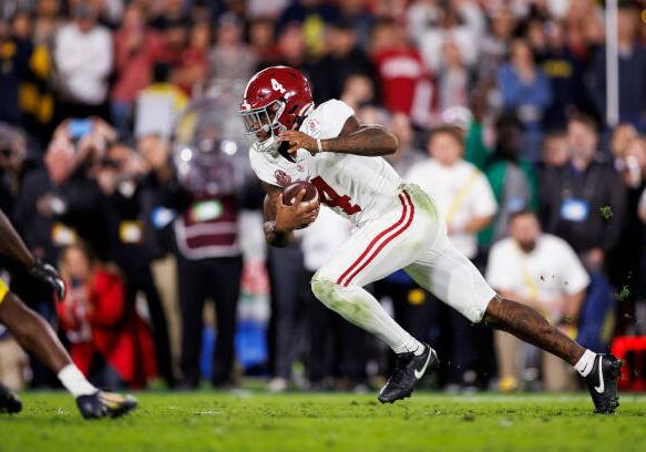 PASADENA, CALIFORNIA - JANUARY 01: Quarterback Jalen Milroe #4 of the Alabama Crimson Tide carries the ball on a run play on the final play in overtime during the CFP Semifinal Rose Bowl Game against the Michigan Wolverines at Rose Bowl Stadium on January 1, 2024 in Pasadena, California. (Photo by Ryan Kang/Getty Images)