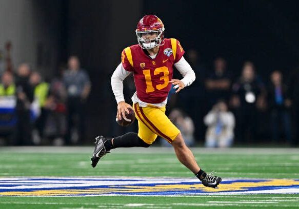 ARLINGTON, TEXAS - JANUARY 02: Quarterback Caleb Williams #13 of the USC Trojans rolls out of the pocket during the second quarter of the Goodyear Cotton Bowl Classic football game against the Tulane Green Wave at AT&amp;T Stadium on January 02, 2023 in Arlington, Texas. (Photo by Alika Jenner/Getty Images)